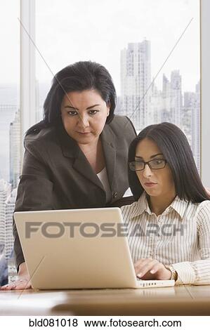 Stock Photo - Businesswomen using laptop. Fotosearch