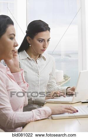 Businesswomen using laptops View Large Photo Image Stock Image - Businesswomen using laptops. Fotosearch