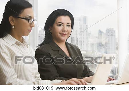 Businesswomen using laptops View Large Photo Image Stock Photo - Businesswomen using laptops. Fotosearch