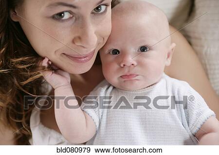 Caucasian mother holding baby View Large Photo Image Stock Photo - Caucasian mother holding baby. Fotosearch