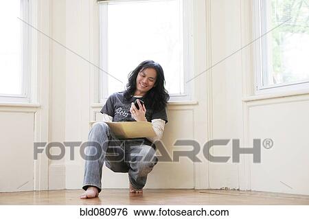 Stock Photograph - Chinese man reading text message. Fotosearch