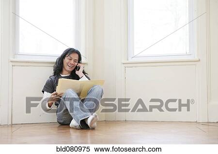 Chinese man sitting on floor using telephone View Large Photo Image Stock Photography - Chinese man sitting on floor using telephone. Fotosearch