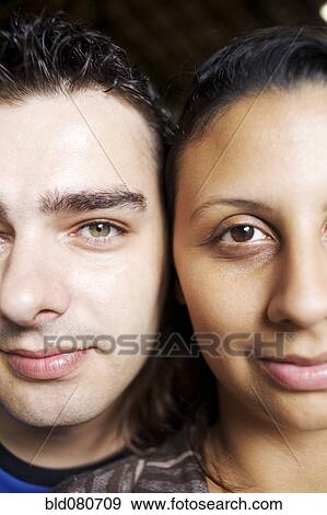 Stock Photo - Couple standing cheek to cheek. Fotosearch