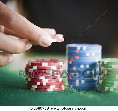 Hand holding gambling chips View Large Photo Image Stock Photo - Hand holding gambling chips. Fotosearch