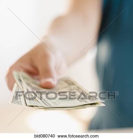 Stock Image - Hand holding money. Fotosearch