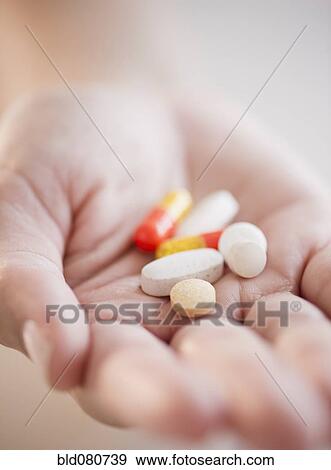 Hand holding pills and capsules View Large Photo Image Stock Photo - Hand holding pills and capsules. Fotosearch