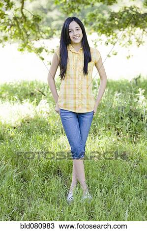 Hispanic girl standing in field View Large Photo Image Stock Image - Hispanic girl standing in field. Fotosearch