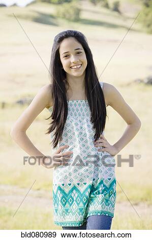 Stock Photo - Hispanic girl standing with hands on hips. Fotosearch