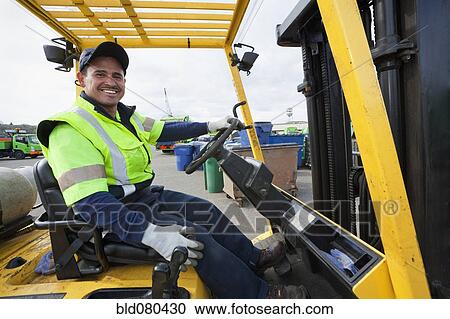 Hispanic man driving forklift View Large Photo Image Stock Image - Hispanic man driving forklift. Fotosearch