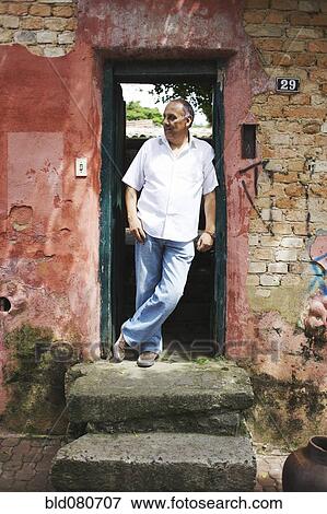 Hispanic man standing in doorway View Large Photo Image Stock Photo - Hispanic man standing in doorway. Fotosearch