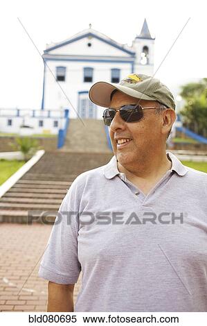 Hispanic tourist standing near church View Large Photo Image Stock Photography - Hispanic tourist standing near church. Fotosearch
