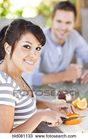 Hispanic woman slicing oranges on patio View Large Photo Image Stock Image - Hispanic woman slicing oranges on patio. Fotosearch