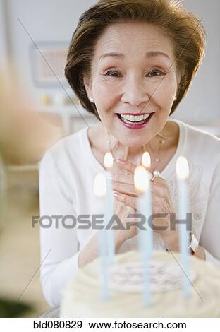 Japanese woman admiring birthday cake View Large Photo Image Stock Photo - Japanese woman admiring birthday cake. Fotosearch
