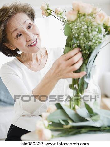 Japanese woman arranging flowers View Large Photo Image Stock Image - Japanese woman arranging flowers. Fotosearch