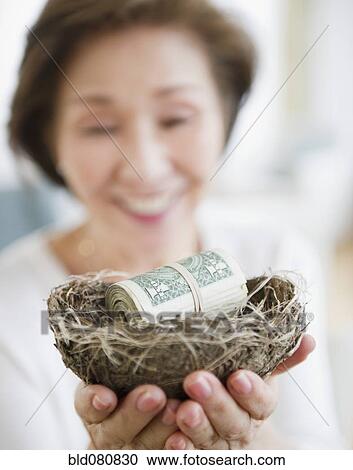 Japanese woman holding nest filled with money View Large Photo Image Stock Image - Japanese woman holding nest filled with money. Fotosearch