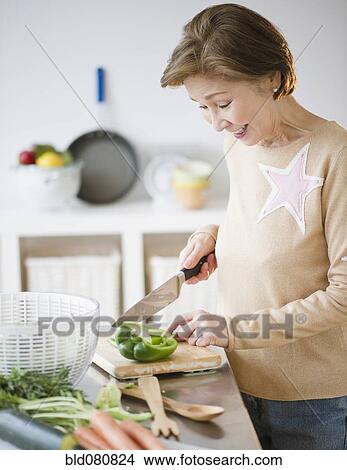 Japanese woman preparing vegetables in kitchen View Large Photo Image Picture - Japanese woman preparing vegetables in kitchen. Fotosearch
