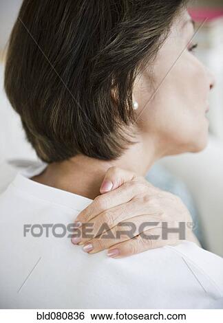 Stock Photograph - Japanese woman rubbing neck and shoulders. Fotosearch