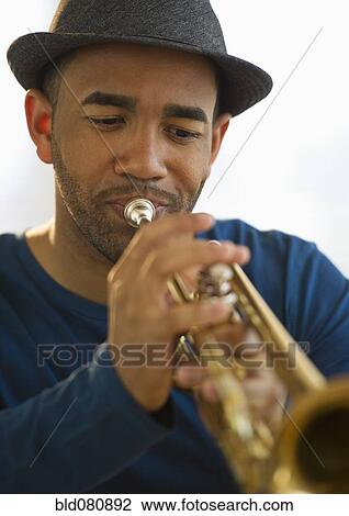 Mixed race man playing trumpet View Large Photo Image Stock Image - Mixed race man playing trumpet. Fotosearch
