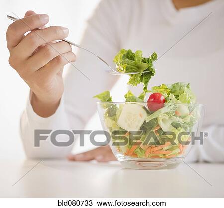 Mixed race woman eating salad View Large Photo Image Stock Image - Mixed race woman eating salad. Fotosearch