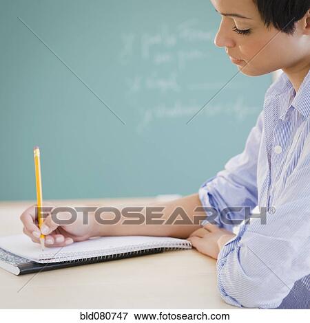 Mixed race woman writing in notebook View Large Photo Image Stock Photo - Mixed race woman writing in notebook. Fotosearch