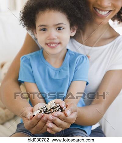 Mother and daughter cupping coins in hands View Large Photo Image Stock Image - Mother and daughter cupping coins in hands. Fotosearch