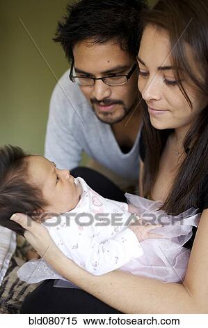 Mother and father looking at newborn baby View Large Photo Image Stock Photography - Mother and father looking at newborn baby. Fotosearch