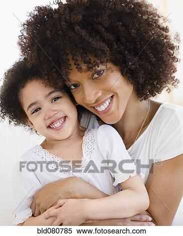 Mother hugging daughter View Large Photo Image Stock Photography - Mother hugging daughter. Fotosearch