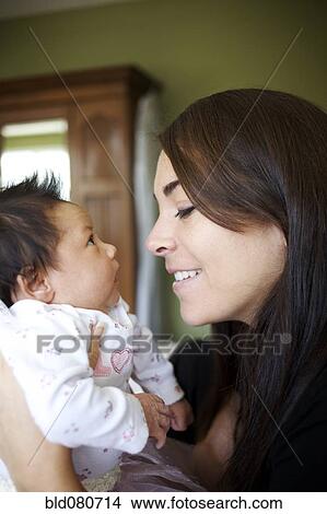 Mother looking at newborn baby View Large Photo Image Picture - Mother looking at newborn baby. Fotosearch
