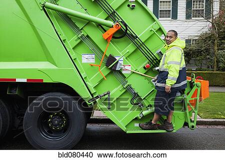 Pacific Islander man riding on garbage truck View Large Photo Image Stock Image - Pacific Islander man riding on garbage truck. Fotosearch