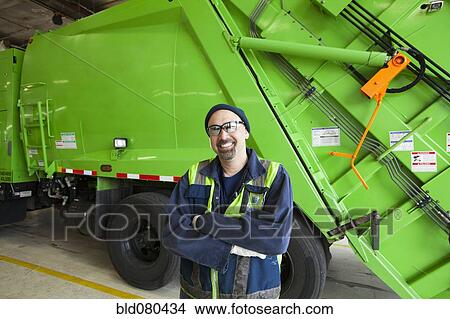 Pacific Islander man standing by garbage truck View Large Photo Image Picture - Pacific Islander man standing by garbage truck. Fotosearch