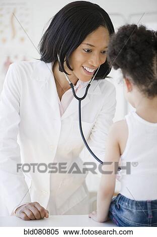 Pediatrician with stethoscope examining patient View Large Photo Image Stock Photography - Pediatrician with stethoscope examining patient. Fotosearch