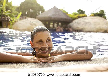 Smiling mixed race woman in swimming pool View Large Photo Image Stock Image - Smiling mixed race woman in swimming pool. Fotosearch