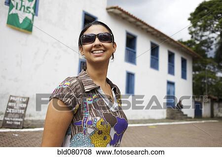 Smiling mixed race woman wearing sunglasses View Large Photo Image Stock Photo - Smiling mixed race woman wearing sunglasses. Fotosearch