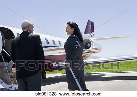 Stock Photo - Business people boarding private jet. Fotosearch