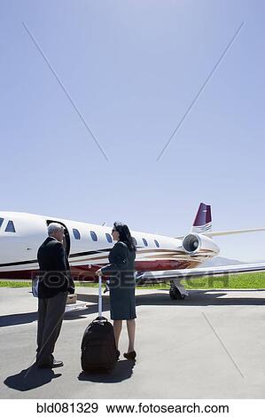 Stock Photo - Business people boarding private jet. Fotosearch