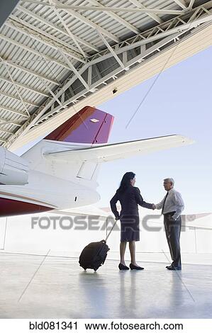 Hispanic business people meeting in airplane hangar View Large Photo Image Stock Image - Hispanic business people meeting in airplane hangar. Fotosearch