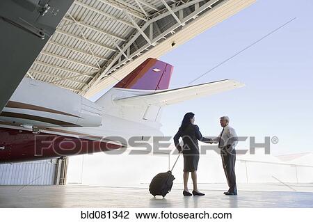 Hispanic business people meeting in airplane hangar View Large Photo Image Stock Image - Hispanic business people meeting in airplane hangar. Fotosearch