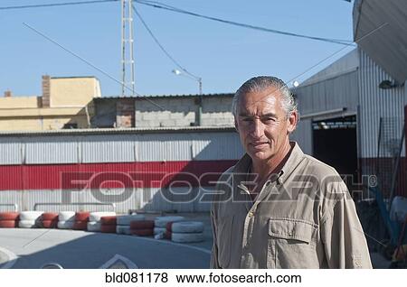 Hispanic mechanic on racetrack View Large Photo Image Stock Photo - Hispanic mechanic on racetrack. Fotosearch