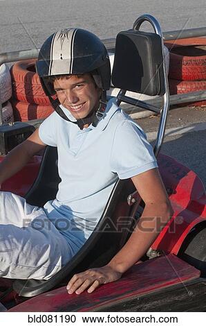 Stock Image - Hispanic teenager on go-cart track. Fotosearch