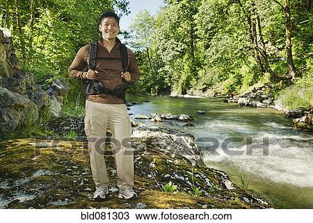 Mixed race man hiking near river View Large Photo Image Stock Image - Mixed race man hiking near river. Fotosearch