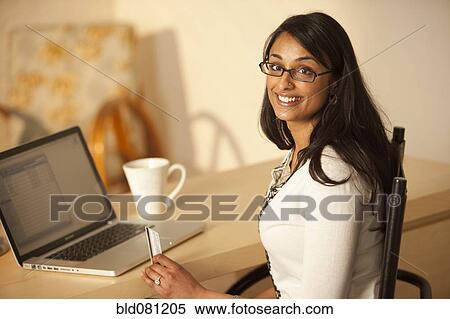 Mixed race woman buying online with credit card View Large Photo Image Stock Photography - Mixed race woman buying online with credit card. Fotosearch