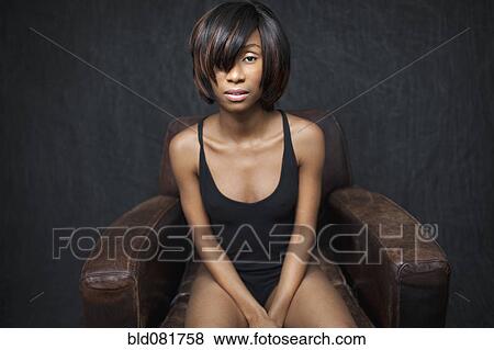 Black woman sitting in leather armchair View Large Photo Image Stock Photo - Black woman sitting in leather armchair. Fotosearch