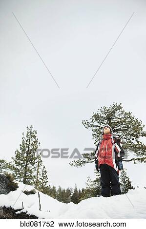 Boy standing in snow and looking up View Large Photo Image Stock Image - Boy standing in snow and looking up. Fotosearch
