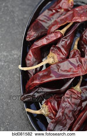 Stock Image - Close up of dried red chilies. Fotosearch