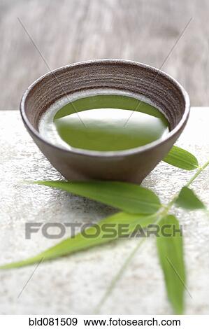 Stock Photo - Close up of Japanese green Matcha tea and bamboo sprig. Fotosearch