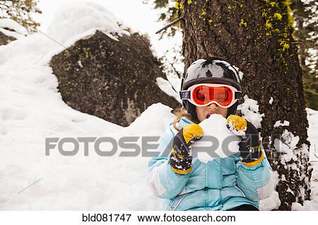 Girl eating snow View Large Photo Image Stock Photo - Girl eating snow. Fotosearch