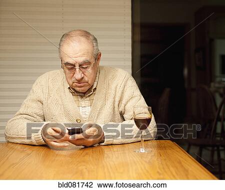 Hispanic man text messaging with cell phone at table View Large Photo Image Stock Image - Hispanic man text messaging with cell phone at table. Fotosearch