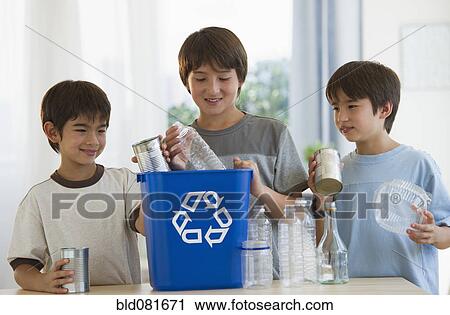 Mixed race brothers recycling plastic bottles and tin cans View Large Photo Image Stock Image - Mixed race brothers recycling plastic bottles and tin cans. Fotosearch