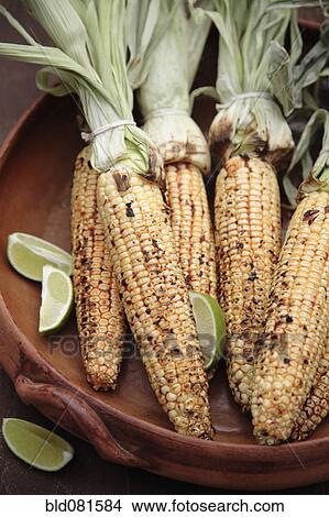 Roasted corn on the cob and limes in bowl View Large Photo Image Picture - Roasted corn on the cob and limes in bowl. Fotosearch