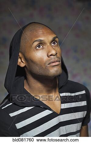 Stock Image - Serious man wearing hoody. Fotosearch